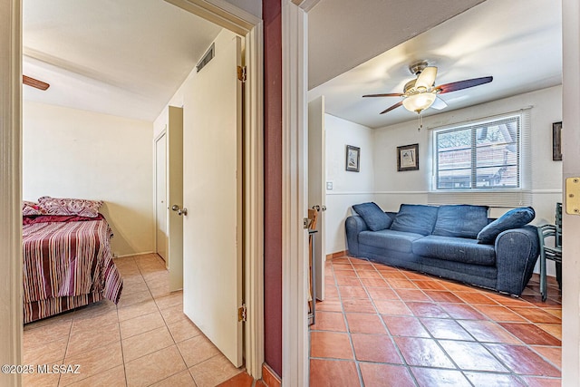 living room featuring ceiling fan, visible vents, and light tile patterned floors