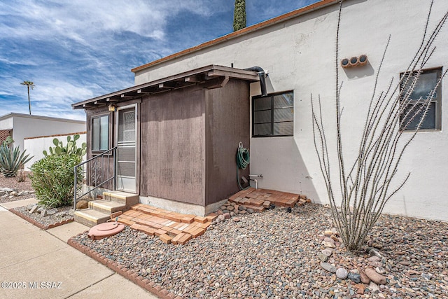 doorway to property with stucco siding
