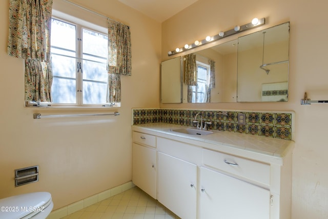 3256 E Terra Alta Blvd, Tucson, AZ 85716 - bathroom featuring toilet, vanity, baseboards, tasteful backsplash, and tile patterned flooring