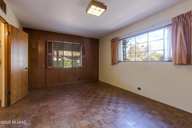 3256 E Terra Alta Blvd, Tucson, AZ 85716 - empty room featuring wood walls and healthy amount of natural light