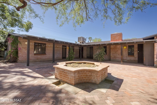3256 E Terra Alta Blvd, Tucson, AZ 85716 - view of patio with an outdoor fire pit and central AC