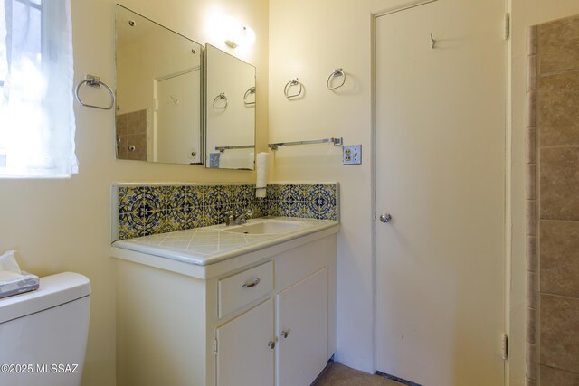 3256 E Terra Alta Blvd, Tucson, AZ 85716 - bathroom featuring toilet, vanity, and decorative backsplash