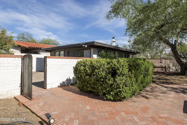 3256 E Terra Alta Blvd, Tucson, AZ 85716 - view of side of home with a gate and fence