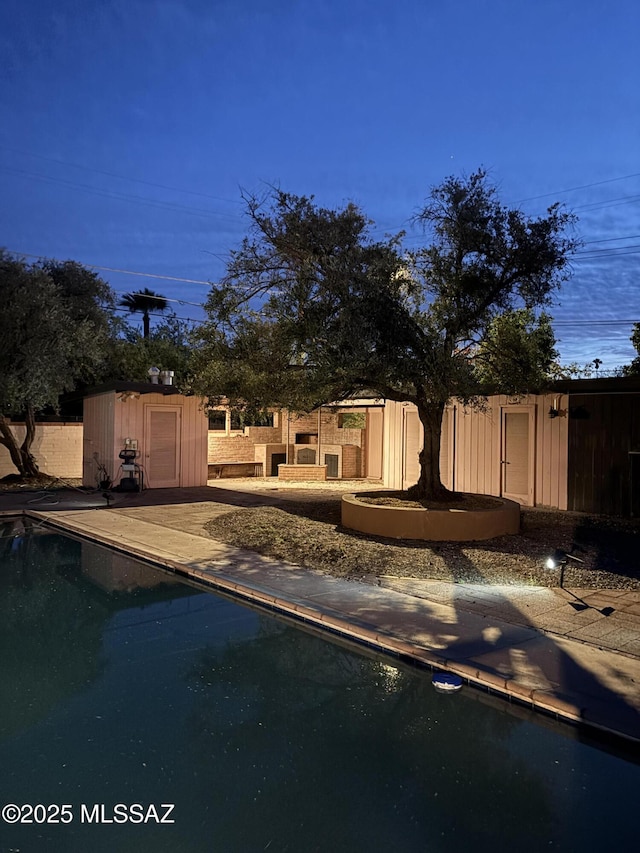 3256 E Terra Alta Blvd, Tucson, AZ 85716 - view of swimming pool featuring a storage shed and an outdoor structure