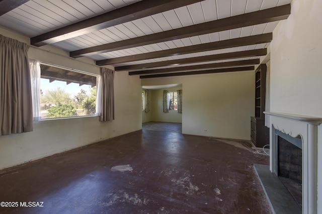 3256 E Terra Alta Blvd, Tucson, AZ 85716 - unfurnished living room with a fireplace with raised hearth, beamed ceiling, and concrete flooring