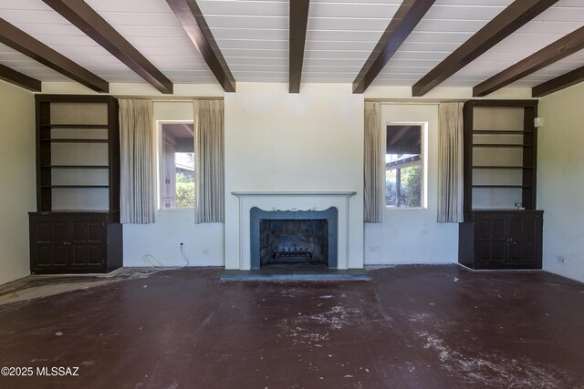 3256 E Terra Alta Blvd, Tucson, AZ 85716 - unfurnished living room featuring beam ceiling, a high end fireplace, plenty of natural light, and concrete floors