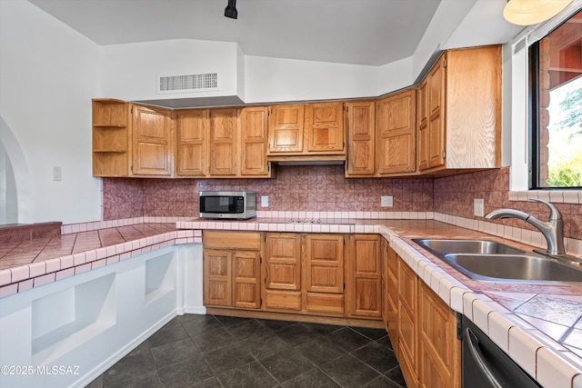 kitchen featuring tile counters, open shelves, visible vents, a sink, and appliances with stainless steel finishes