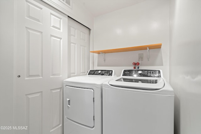 washroom featuring washer and dryer and laundry area