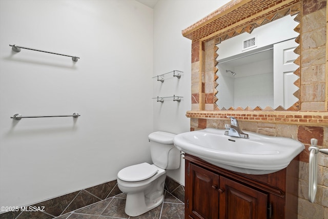 bathroom featuring marble finish floor, visible vents, toilet, vanity, and baseboards