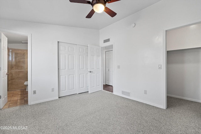 unfurnished bedroom with carpet floors, visible vents, baseboards, and connected bathroom