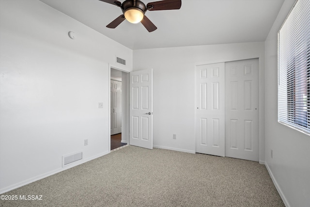 unfurnished bedroom with visible vents, baseboards, carpet flooring, and a closet