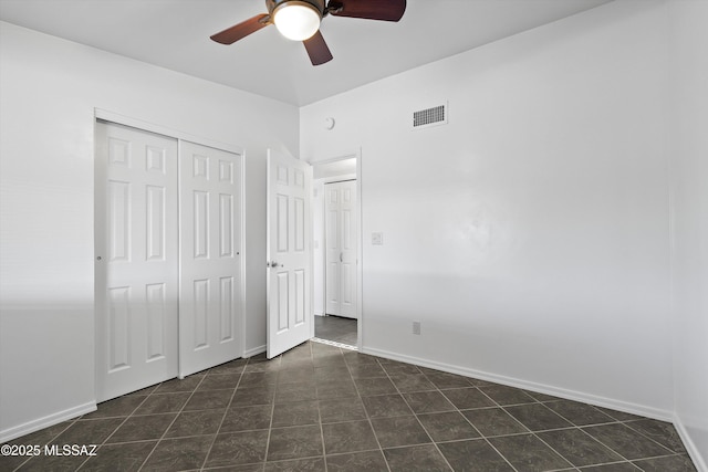 unfurnished bedroom with a closet, visible vents, a ceiling fan, and baseboards