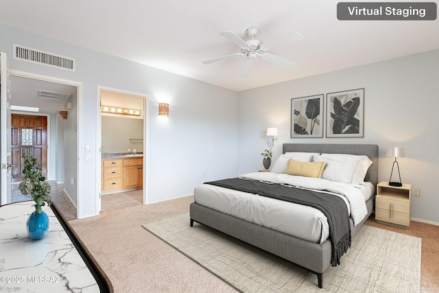 bedroom featuring light colored carpet, visible vents, and a sink