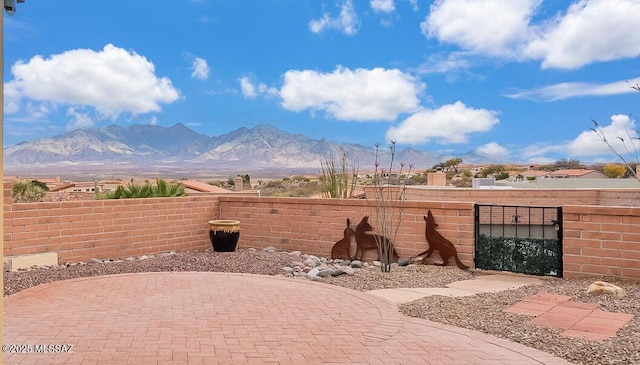 exterior space featuring fence and a mountain view