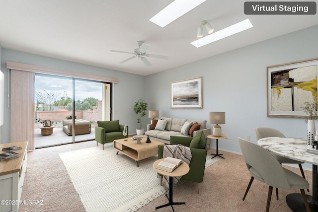 carpeted living room with baseboards, ceiling fan, and a skylight