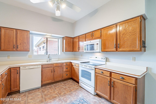 kitchen with light countertops, white appliances, a sink, a ceiling fan, and brown cabinetry