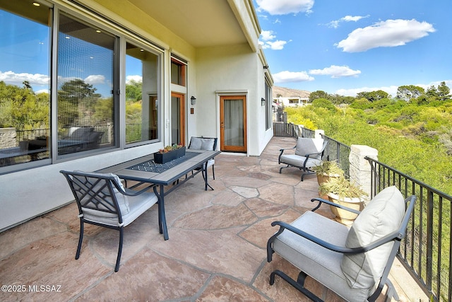 view of patio featuring a balcony