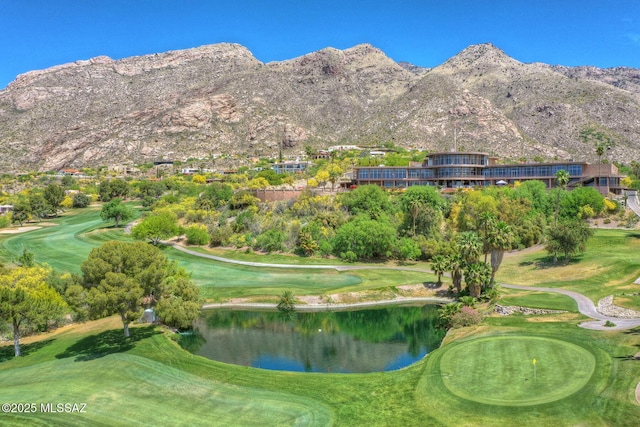 view of mountain feature with golf course view and a water view