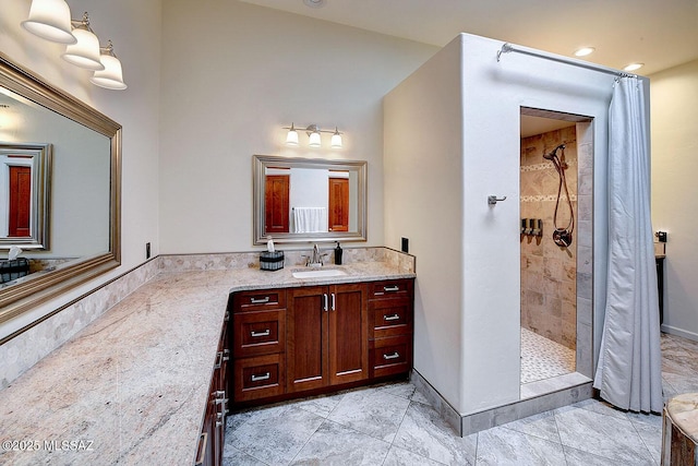 bathroom featuring vanity and a tile shower