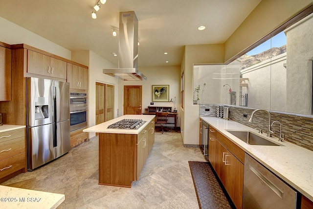kitchen featuring island exhaust hood, a sink, tasteful backsplash, a kitchen island, and appliances with stainless steel finishes