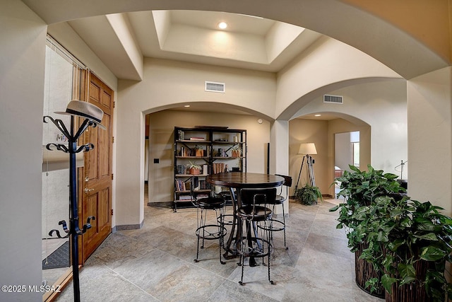 dining space featuring arched walkways and visible vents