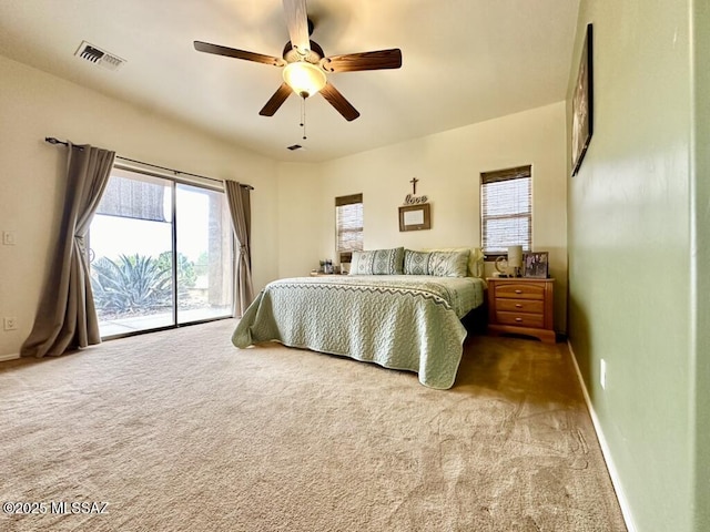 bedroom featuring carpet, access to outside, baseboards, and visible vents