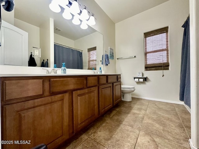 bathroom featuring double vanity, tile patterned flooring, toilet, visible vents, and a sink
