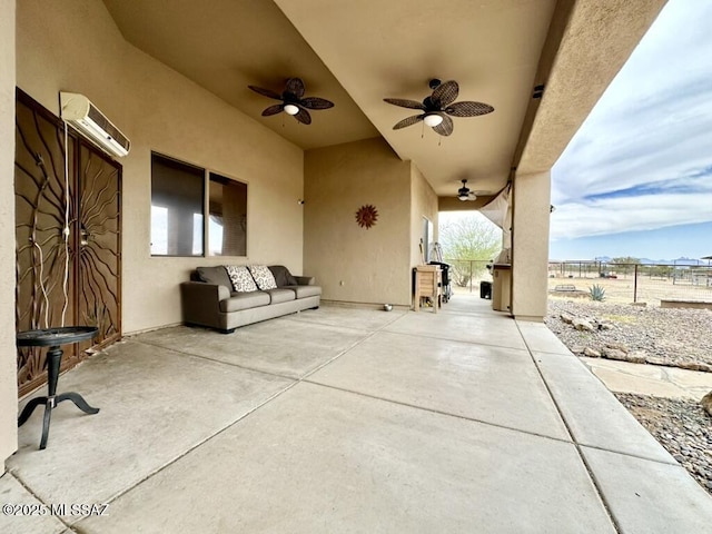view of patio / terrace featuring ceiling fan, fence, and a wall mounted air conditioner