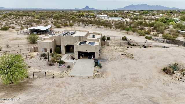 birds eye view of property with a mountain view and view of desert