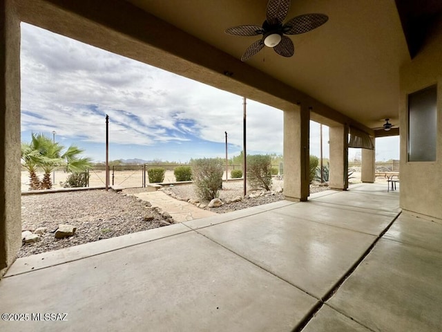 view of patio featuring fence and ceiling fan
