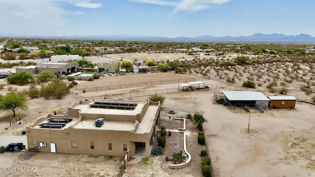 drone / aerial view with a rural view, a mountain view, and a desert view