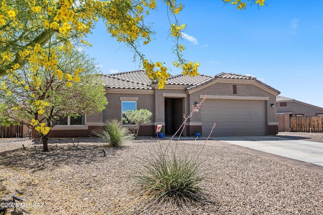 ranch-style house with a tiled roof, driveway, fence, an attached garage, and stucco siding