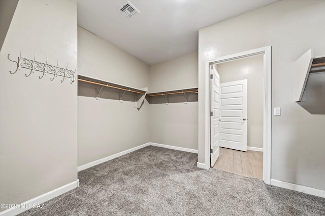 walk in closet with carpet floors and visible vents