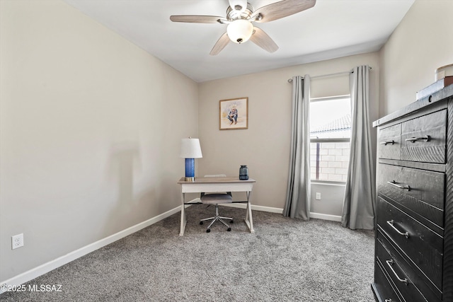 carpeted office with a ceiling fan and baseboards