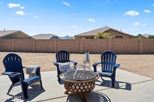view of patio featuring a fenced backyard and an outdoor fire pit