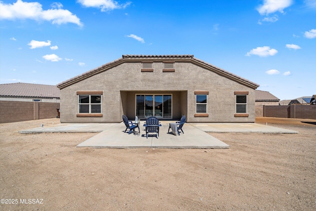 rear view of house featuring a patio area, a fenced backyard, and stucco siding