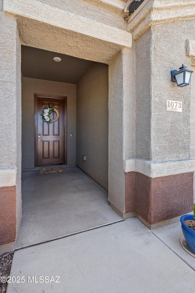 view of exterior entry with stucco siding