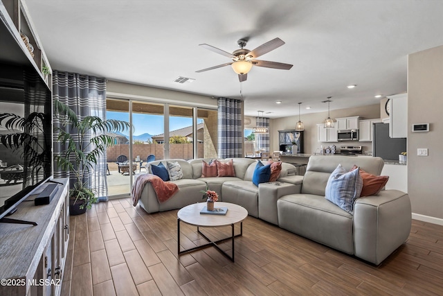 living room featuring recessed lighting, visible vents, a ceiling fan, baseboards, and dark wood-style flooring