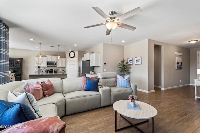 living room with baseboards, recessed lighting, ceiling fan, and dark wood-style flooring