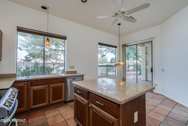 kitchen featuring hanging light fixtures, a sink, a ceiling fan, stainless steel appliances, and a kitchen island