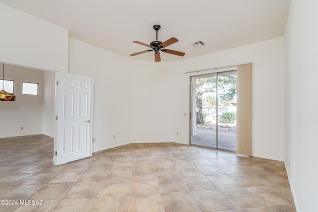 empty room with visible vents, baseboards, and a ceiling fan