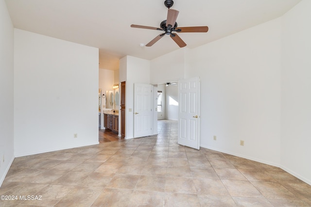 spare room with baseboards, light tile patterned flooring, and ceiling fan