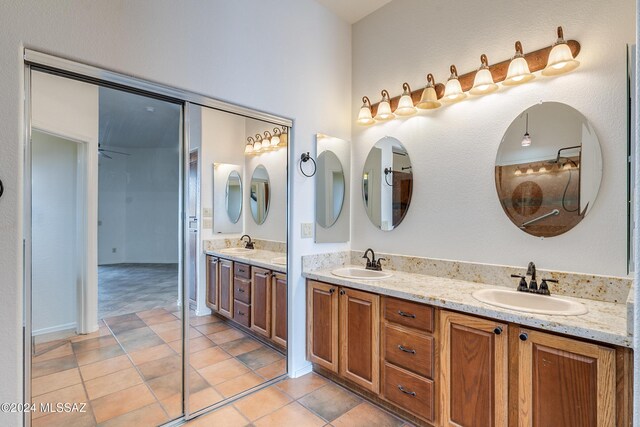 full bathroom featuring a sink, tile patterned floors, and double vanity