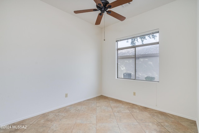unfurnished room with ceiling fan, baseboards, visible vents, and light tile patterned floors