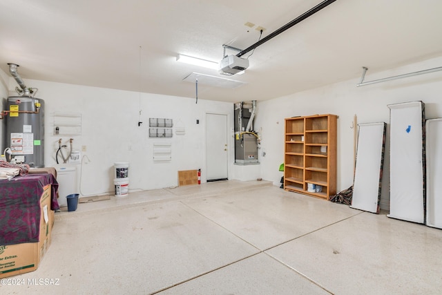 garage with heating unit, a garage door opener, and gas water heater