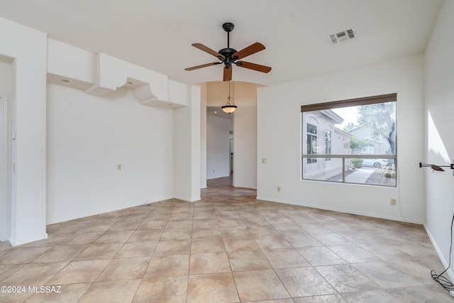 spare room with ceiling fan, baseboards, and visible vents