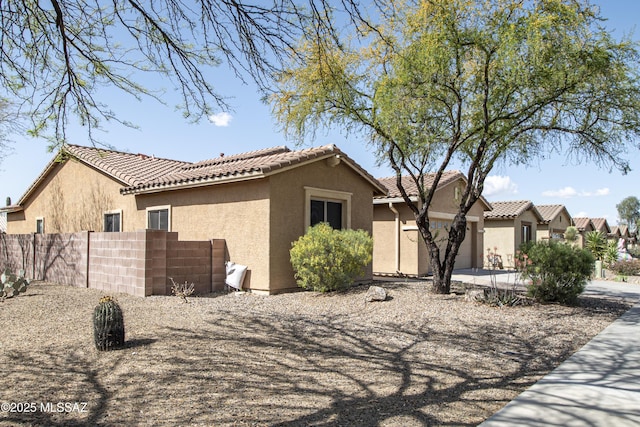 1419 W Red Creek Dr, Tucson, AZ 85737 - view of front of house featuring stucco siding, a tiled roof, and a garage