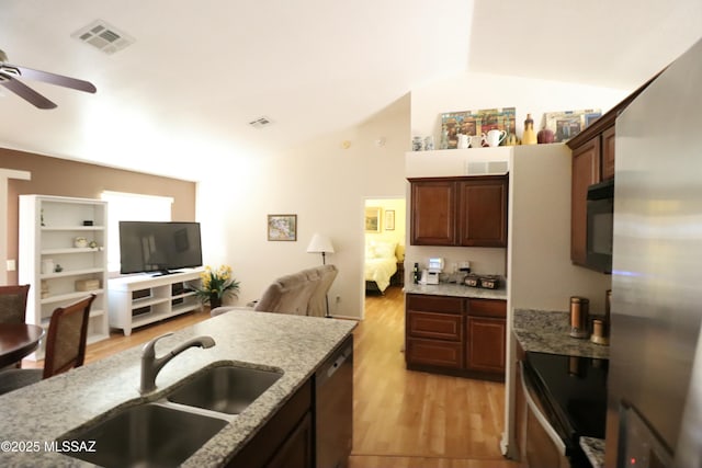 kitchen with open floor plan, a ceiling fan, visible vents, stainless steel appliances, and a sink