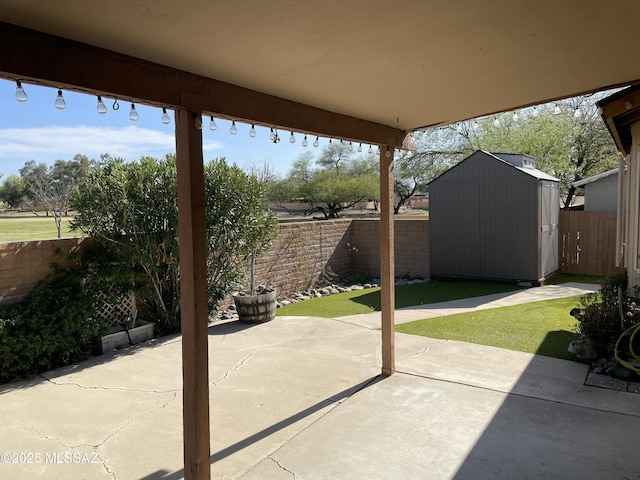 view of patio / terrace featuring a shed, a fenced backyard, and an outdoor structure