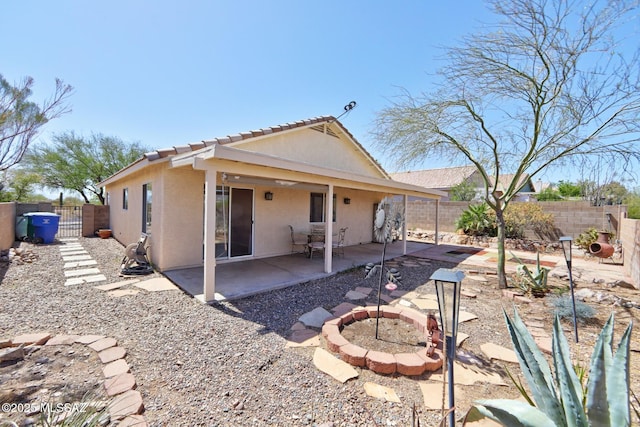 3625 N Avenida Albor, Tucson, AZ 85745 - back of house with stucco siding, a fenced backyard, a patio area, a tiled roof, and a gate